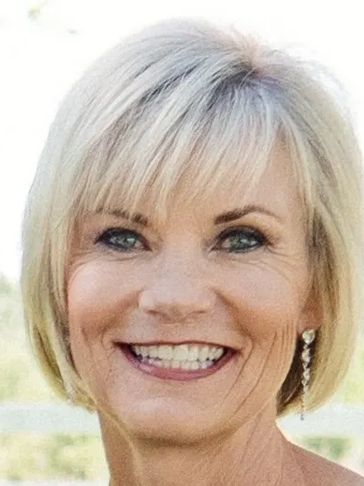 Mollie Young, founding principal of MYBA and brand and product naming expert smiling outdoors.