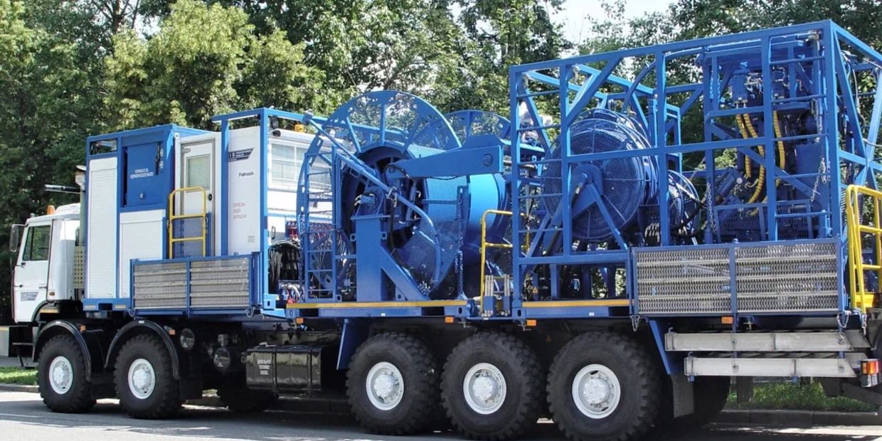 Large heavy-duty blue industrial truck with cable reels.