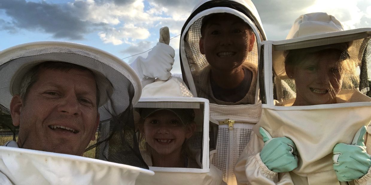 The Newborn family in our beekeeping suits to work the honey bees on Passion Farm of Florida.