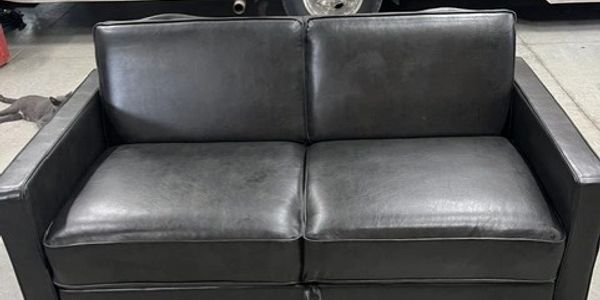 Black leather loveseat sofa.