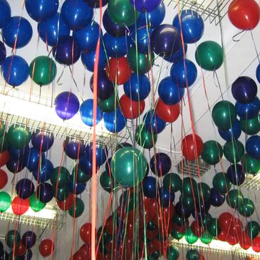 Colorful balloons floating indoors.