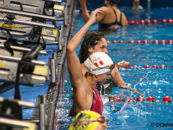 Swimmers celebrate at the poolside after a race.