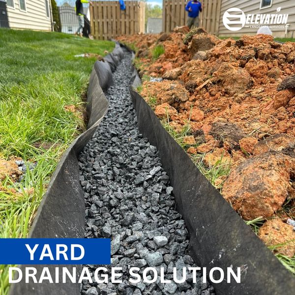 Yard drainage solution with gravel and fabric liner.