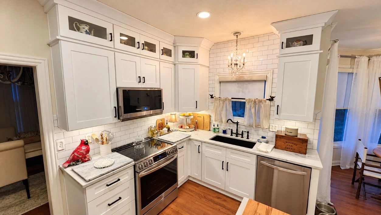 Bright white kitchen with modern appliances and decorative accents.