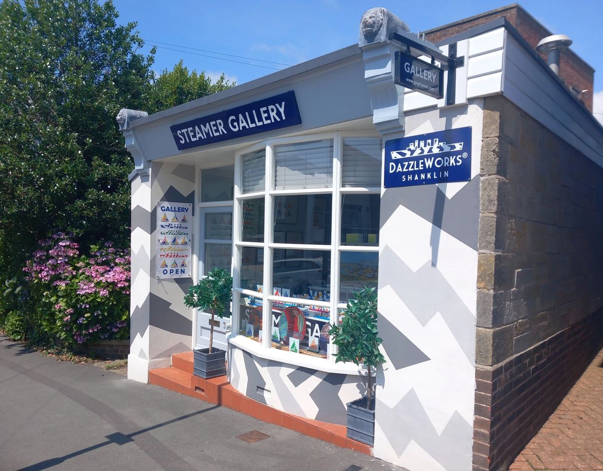 Steamer Gallery exterior with geometric patterns and potted plants.