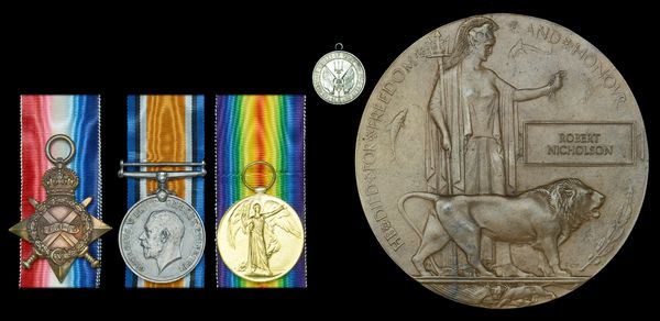 Set of three military medals and a memorial plaque with the name Robert Nicholson.