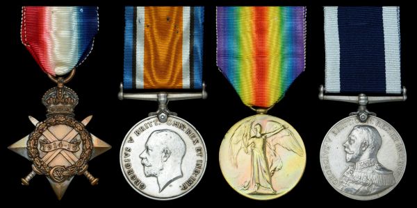 Four distinct military medals with colorful ribbons on a black background.
