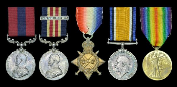 Five vintage military medals with colorful ribbons displayed in a row.