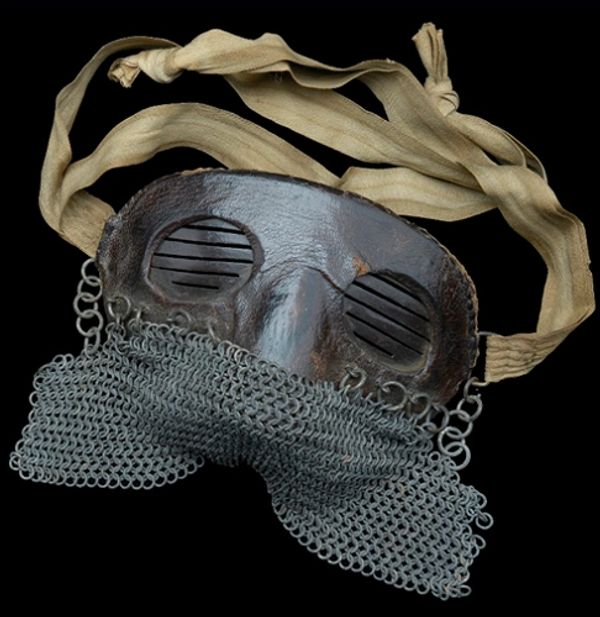 Medieval leather and chainmail half-mask with fabric straps.