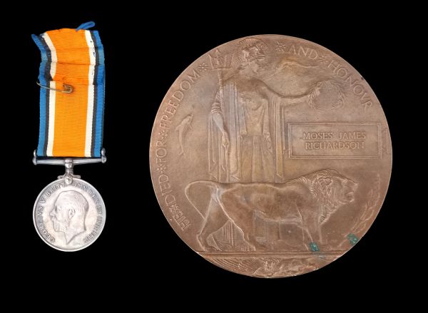 A silver medal with a ribbon and a bronze commemorative plaque honoring Moses James Richardson.