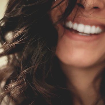 Woman laughing. Photo by Lesly Juarez on Unsplash.