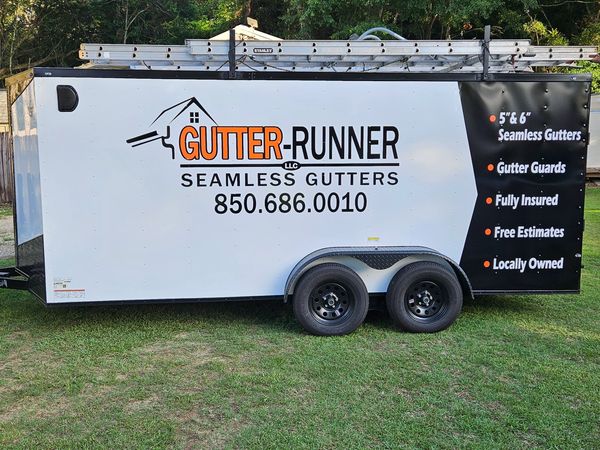 Trailer advertising seamless gutter services with contact info and features.