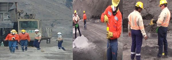 Workers in safety gear conducting operations in a mining site.