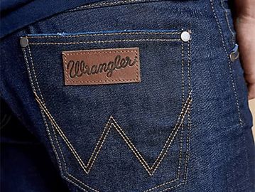 Close-up of a Wrangler denim jeans back pocket with brand label.