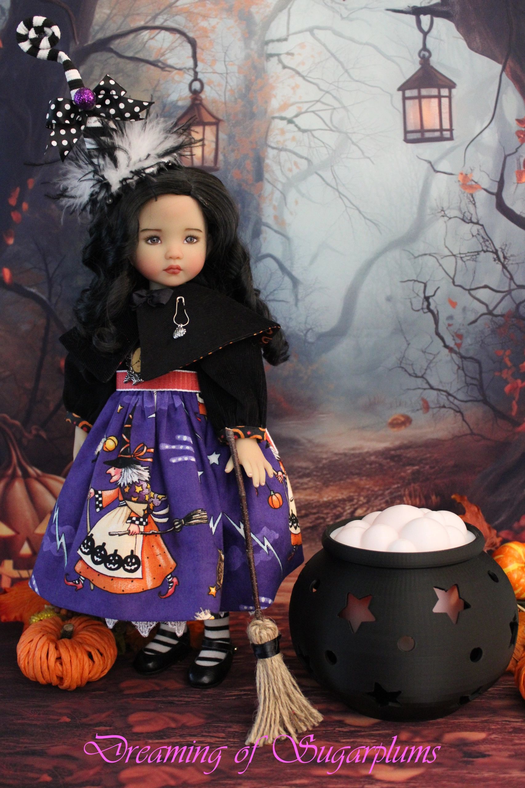 A doll dressed as a witch with a festive purple Halloween dress.