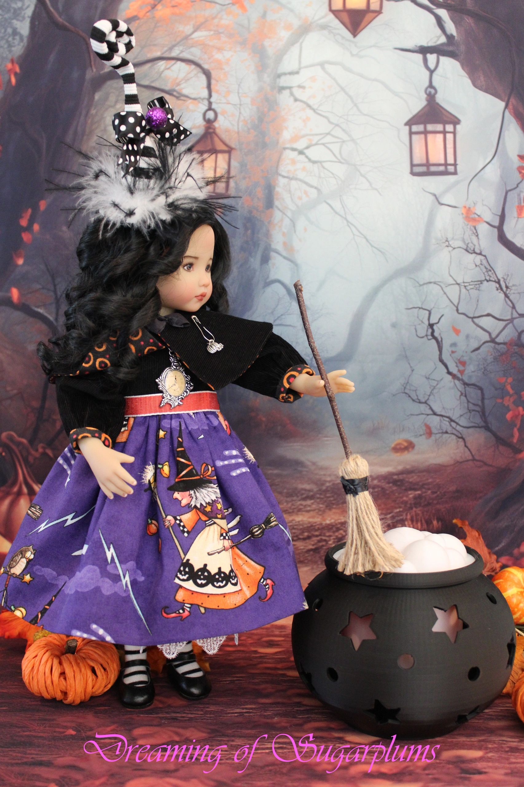 Halloween-themed doll with a broomstick and cauldron.