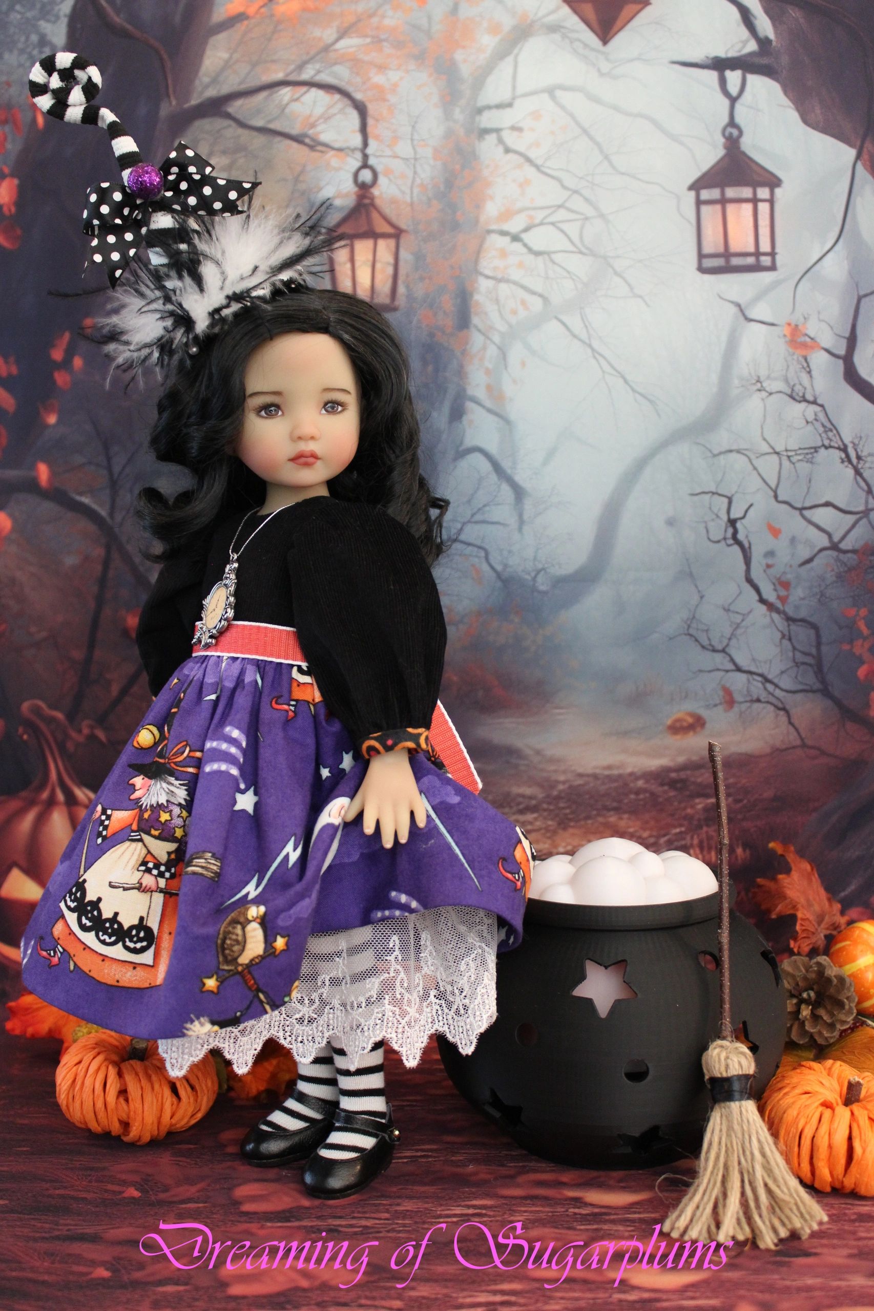 Halloween-themed doll in a forest scene with pumpkins and lanterns.