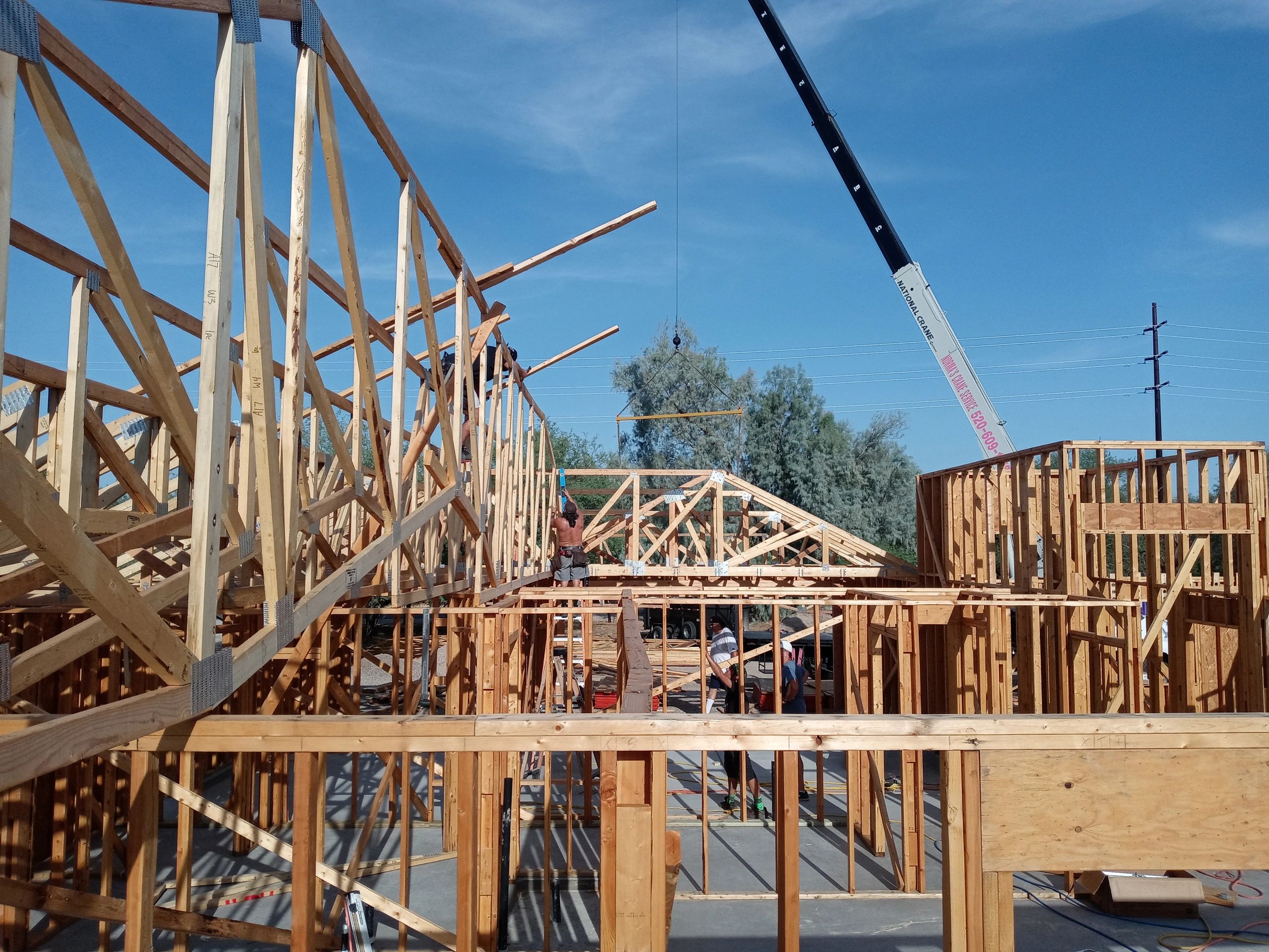 Linwood Development Company crew installing a 16ft. x 56 ft. Long Hip roof truss to girder truss.