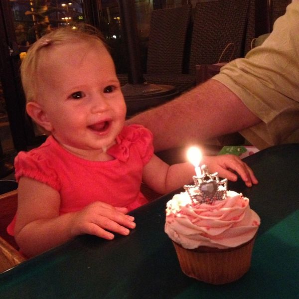 little girl blowing a birthday candle 