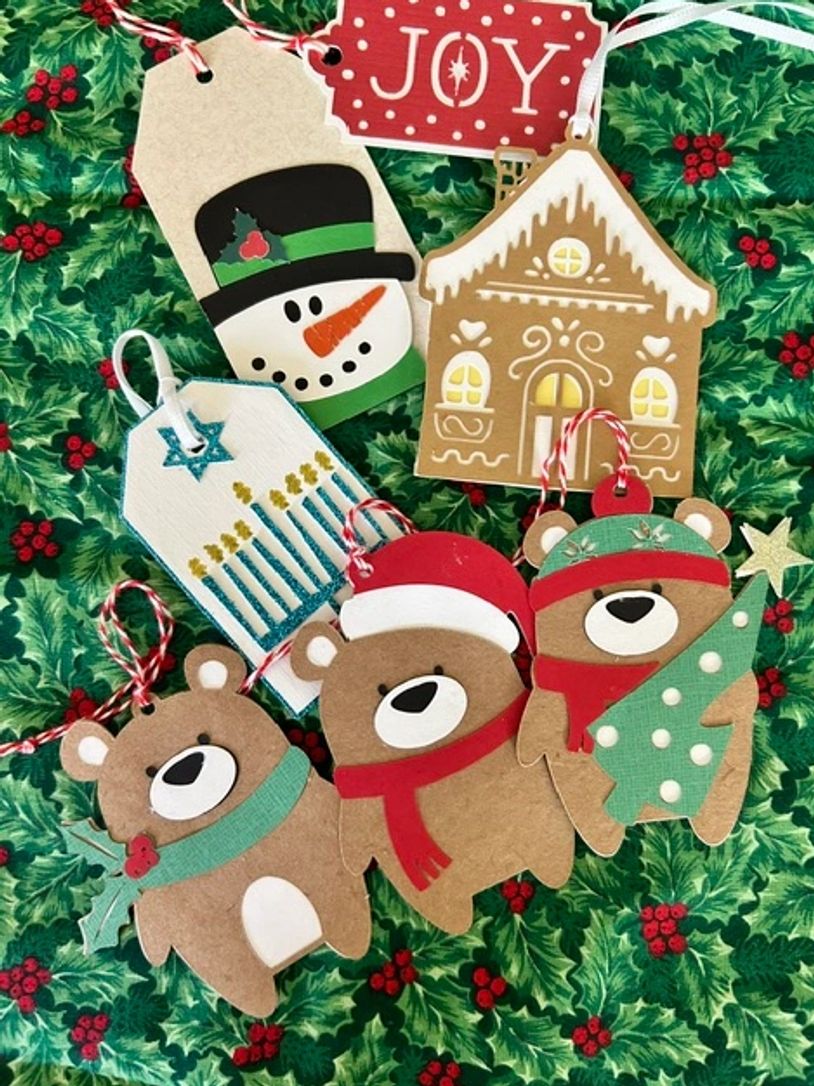 Festive holiday tags and ornaments with bears, snowman, gingerbread house, and menorah.