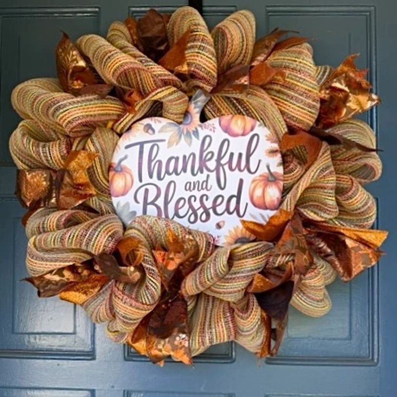 Autumn wreath with a 'Thankful and Blessed' sign on a door.