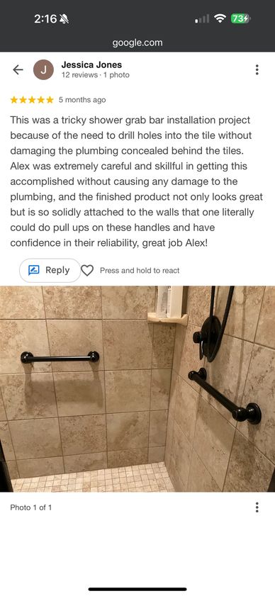 Shower with solidly installed grab bars on tiled walls.