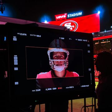 Camera screen showing football player at Levi's Stadium during night.
