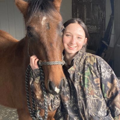 Abilene with her Warm Springs Mustang Lahaina, staying out of the cold wind by hanging out in the ga