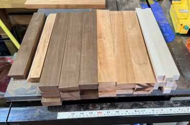 Various wooden planks neatly arranged on a workbench with a measuring ruler.
