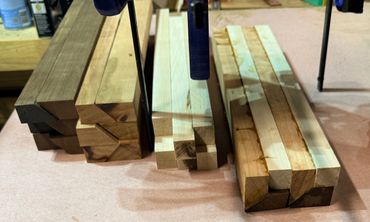 Stacked wooden beams with different grains and colors.