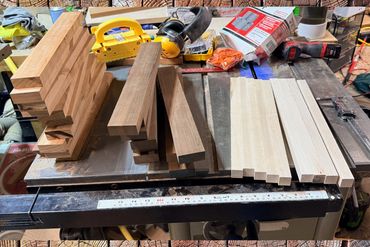 Woodworking project with neatly cut wooden pieces on a workbench.