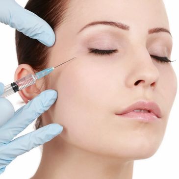 A woman receiving a cosmetic injection near her eye.