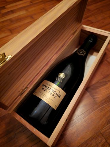 A bottle of Bollinger 1995 Champagne in a wooden box.