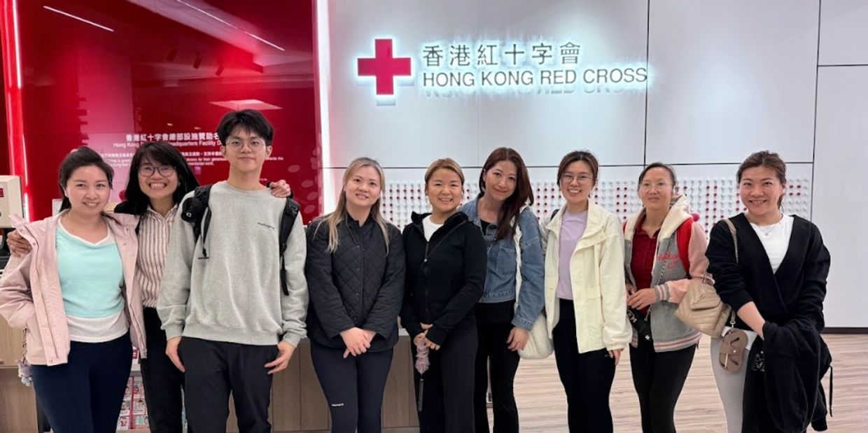 Group of people posing inside the Hong Kong Red Cross building.