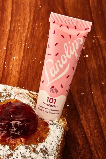 Pink Lanolips 101 Raspberry Shortcake ointment tube on bread with jam.