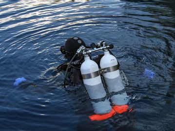 Diver at the surface in a twin-cylinder sidemount configuration