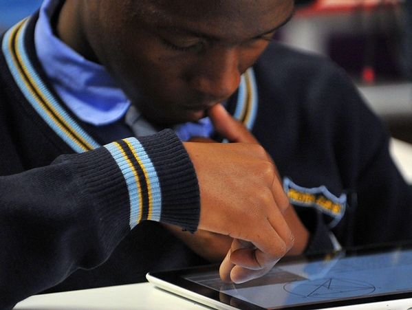 Student using a tablet with a stylus pen.