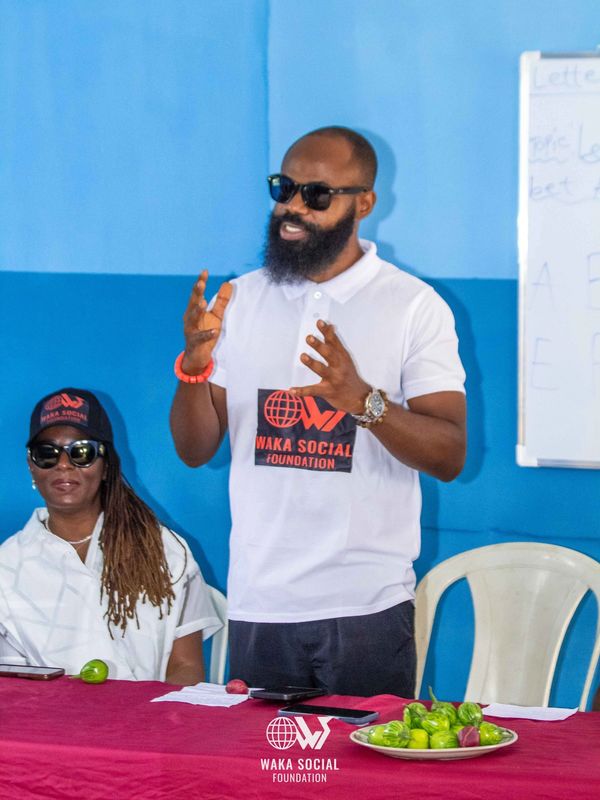 Man speaking at Waka Social Foundation event.