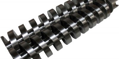 Close-up of metal screw conveyor blades.