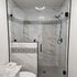 Matte Black hardware, swing door frameless shower glass