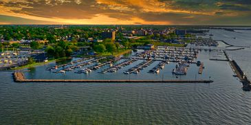 Aerial view of a marina filled with boats at sunset.