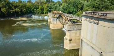 View of the Prairie River Dam surrounded by green trees