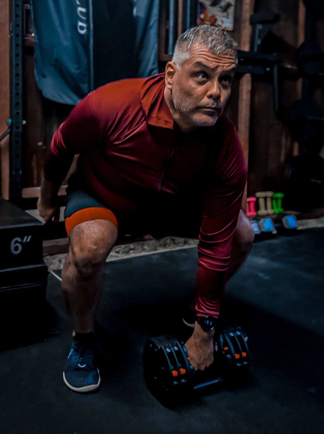 Man lifting dumbbells in a gym.