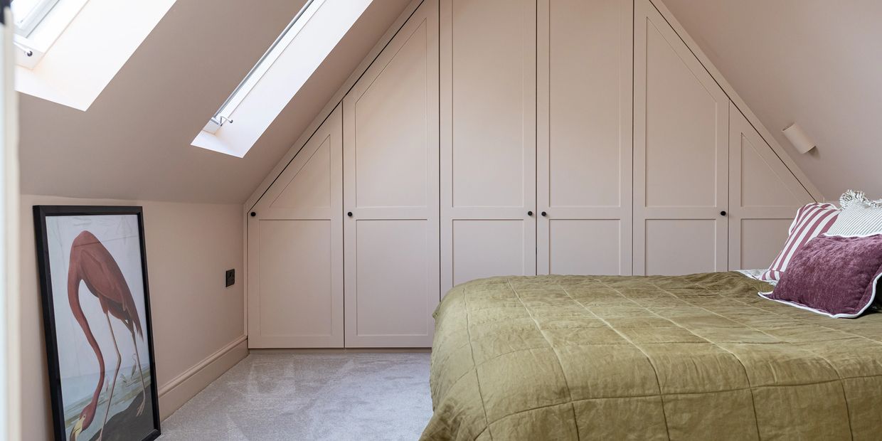 Brentwood loft bedroom with fitted wardrobes beneath the roof slopes and two rooflights.