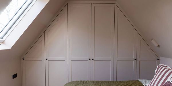 Brentwood loft bedroom with fitted wardrobes beneath the sloping roof and a rooflight.