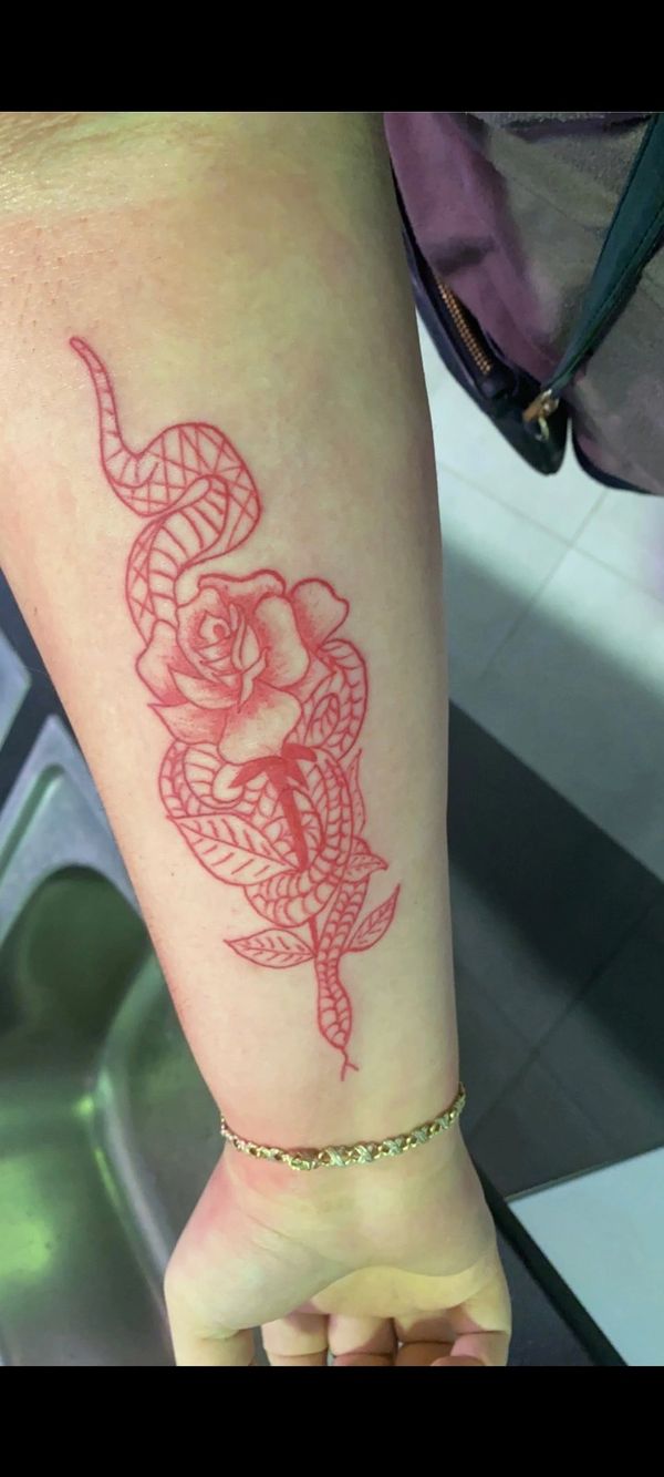 Rose and snake in red ink tattoo