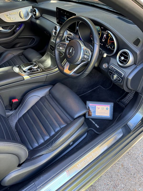 Luxury Mercedes-Benz interior with black leather seats and advanced dashboard.