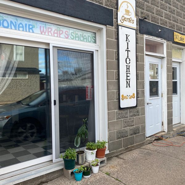 Front entrance for Garth’s Kitchen with signage and herb planters