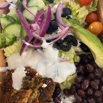 Buddha bowl with rice, beans, falafel, and salad