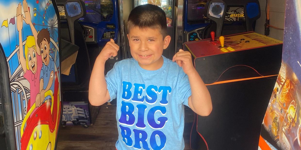 A picture of William having a blast with the Party Trailer Arcade Games.